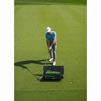 Golfer using a modern golf analytics device to analyze swing data on a green, with data overlays
