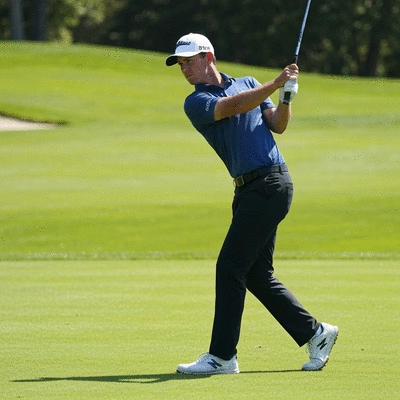 Professional golfer demonstrating proper weight shift in a golf swing, dynamic pose on a green golf course