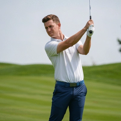 Golfer focusing on their swing with a calm expression